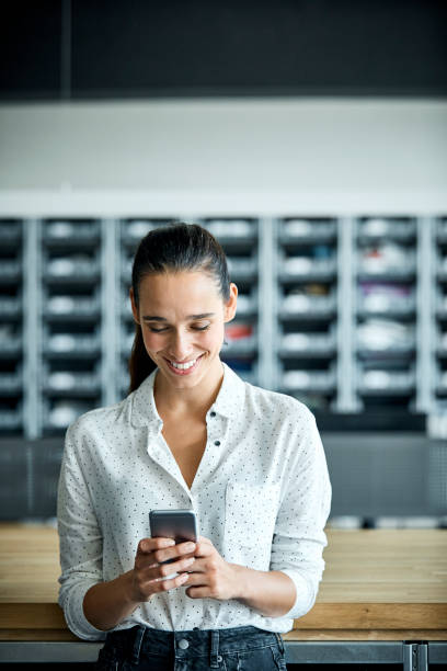 businesswoman using smart phone in textile factory - guardare verso il basso foto e immagini stock