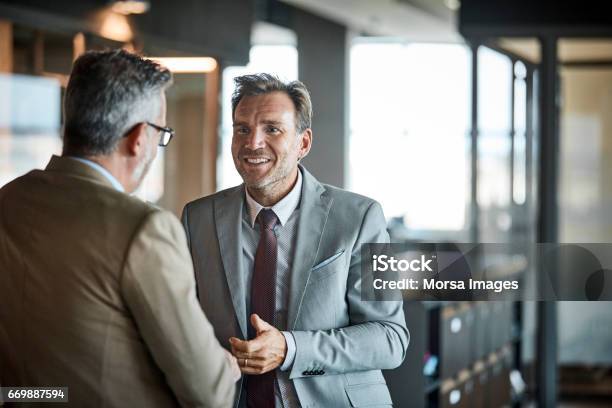 Businessmen Communicating In Textile Factory Stock Photo - Download Image Now - Discussion, Business, Businessman