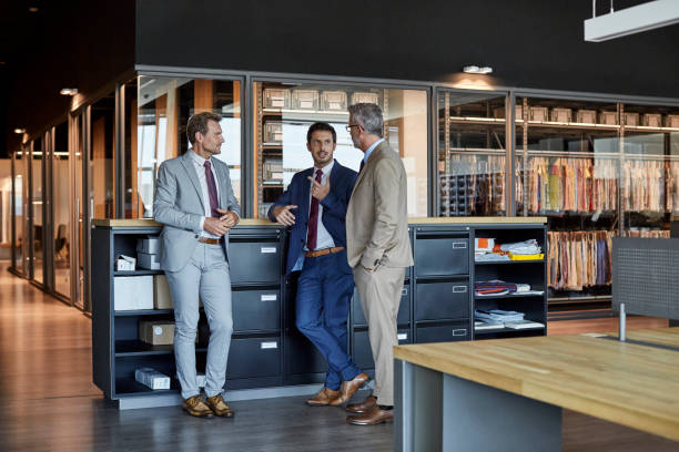 businessmen communicating in textile factory - plant stand стоковые фото и изображения