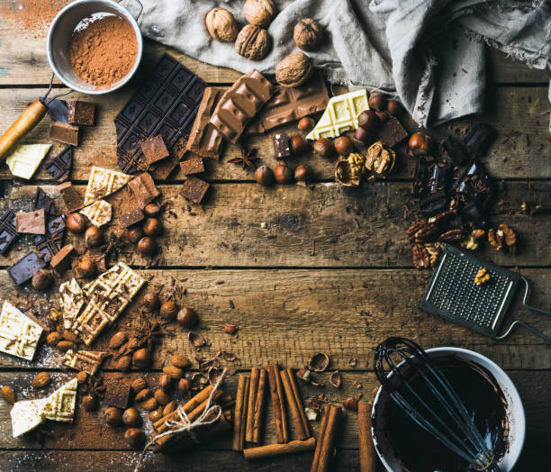 istock Background with chocolate, nuts and spices over wooden backdrop 669888374