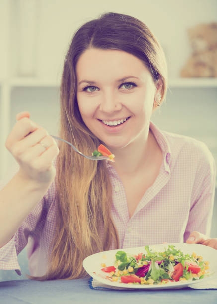 istock Woman tasting fresh green salad 669895078