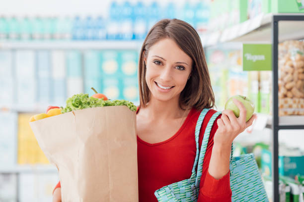 istock Woman buying fresh vegetables 669895448