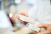 Cropped image of pharmacist holding medicines