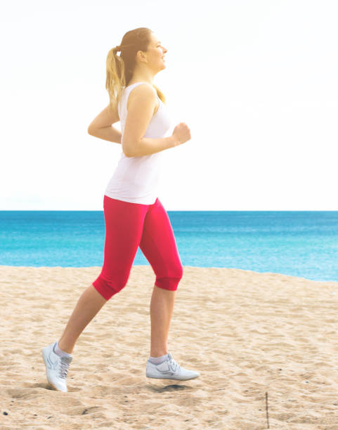 istock Woman running on beach 669896058