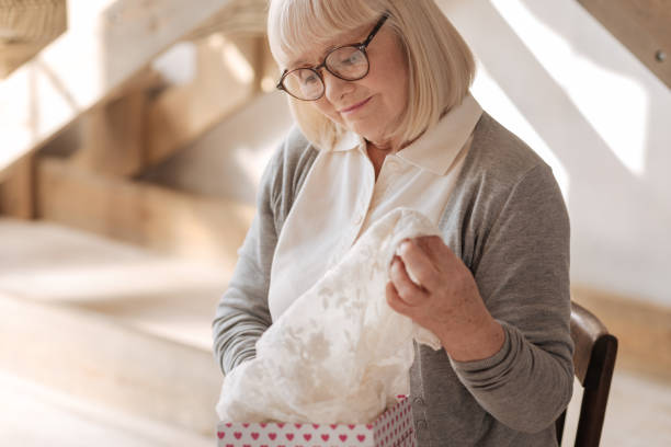 istock Delighted nice woman opening a gift 669898842