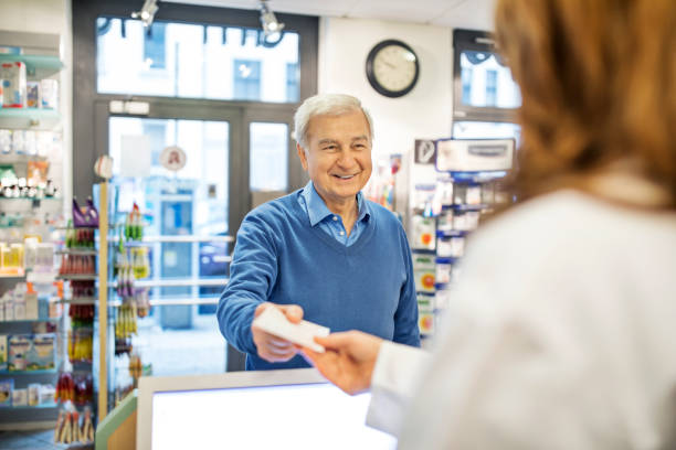 istock Smiling senior man giving prescription to chemist 669899242