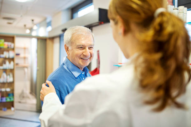istock Pharmacist consoling senior man in store 669899506