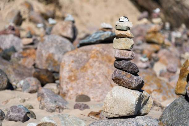istock Pyramid of pebbles on the beach - stuck rocks 669899562