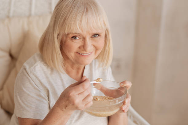 istock Cheerful positive woman enjoying her breakfast 669902450