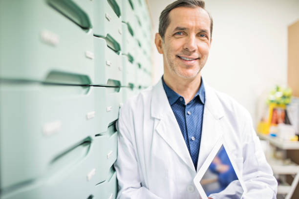 istock Pharmacist holding digital tablet in storage room 669902526