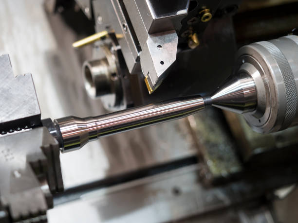 istock operator machining mold and die part by CNC turning machine in factory 669902532