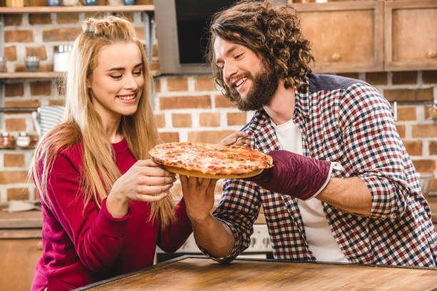 istock Young couple together at kitchen 669902648