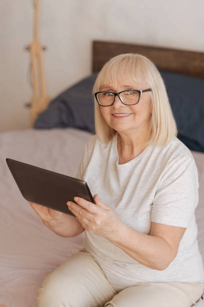 istock Nice good looking woman holding a tablet 669902718