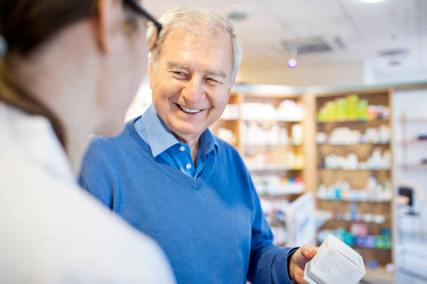 istock Happy senior man buying medicine from pharmacist 669902884