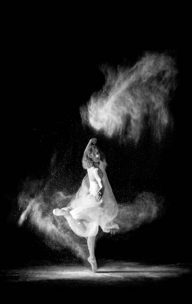 istock Beautiful ballet dancer, dancing with powder on stage 669903592