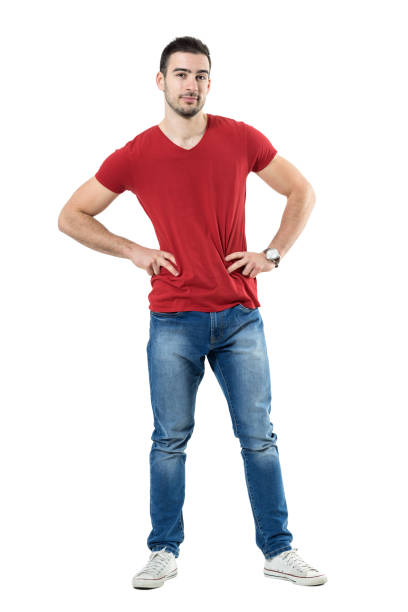 istock Young cool relaxed guy with hands on hips looking at camera 669907080