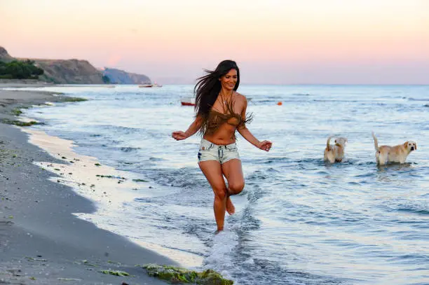 Photo of Beautifu woman running on the beach