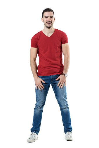 Relaxed young laughing casual man looking at camera. Full body length portrait isolated over white studio background.