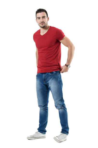 istock Friendly young guy adjusting red t-shirt backside looking at camera. 669908328