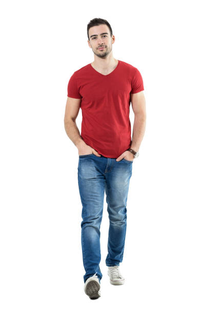 istock Cool relaxed casual guy with hands in pockets walking and looking at camera. 669908366
