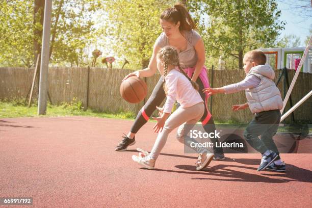 Mother Paying Basketball Wit Her Children Stock Photo - Download Image Now - Basketball - Sport, Mother, Child