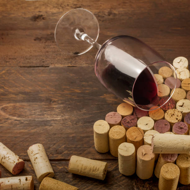 istock Glass of red wine and corks with place for text 669918426