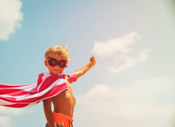 istock little boy play superhero at sky 669921688