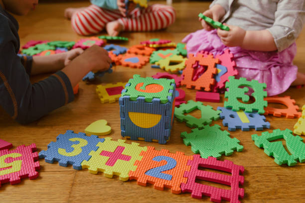 kinder spielen mit puzzle, bildungskonzept - child mathematics education mathematical symbol stock-fotos und bilder