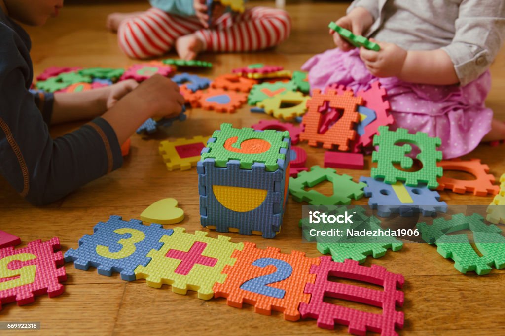 kids playing with puzzle, education concept kids playing with number puzzle, education concept Child Care Stock Photo