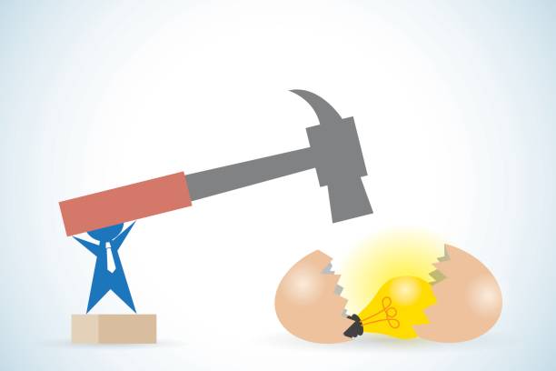 istock businessman holding hammer to break egg and get light bulb, idea and business concept 669923080