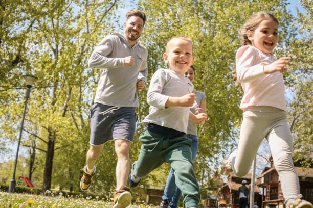 istock Cheerful father playing with his children's. 669926484