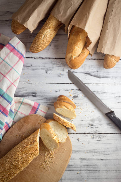 istock French baguette cut with a knife on cutting board 669927668