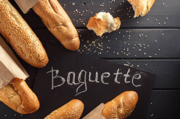 istock French baguettes with sesame seed on black wooden background 669927850