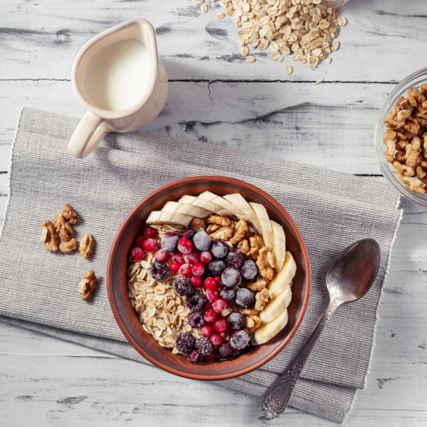 istock Oatmeal in bowl with berries, bananas and walnuts 669930176