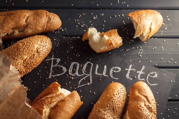 istock French baguettes with sesame seed on black wooden background 669930536