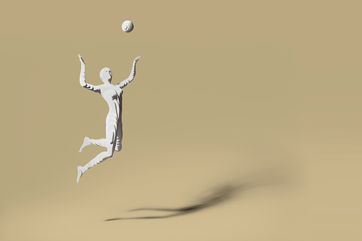 Hand cut layers of paper to make a figure of a female volleyball player