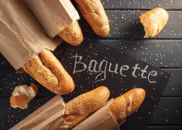 istock French baguettes with sesame seed on black wooden background 669931728