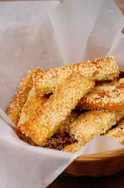 Slices of toast fried in breaded with cheese and sesame in a basket