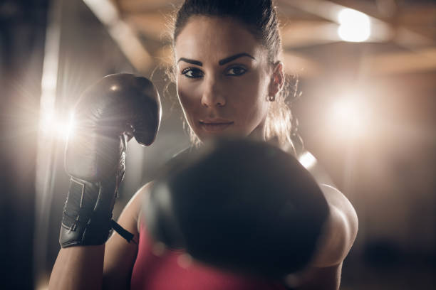 istock Young female boxer on a sports training in a gym. 669936612
