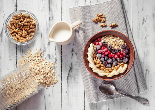 istock Oatmeal in bowl with berries, bananas and walnuts 669936906