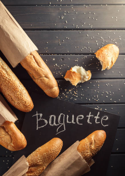 istock French baguettes with sesame seed on black wooden background 669937696