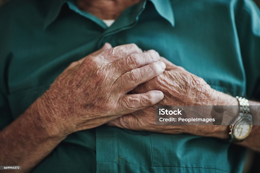 I'm still young here... Cropped shot of an unrecognizable senior male sitting indoors Heart Disease Stock Photo