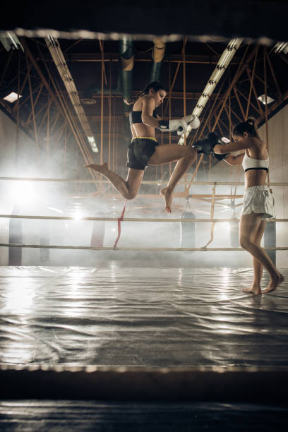 istock Athletic woman making a flying move on a kickboxing match with her sparing partner. 669941246