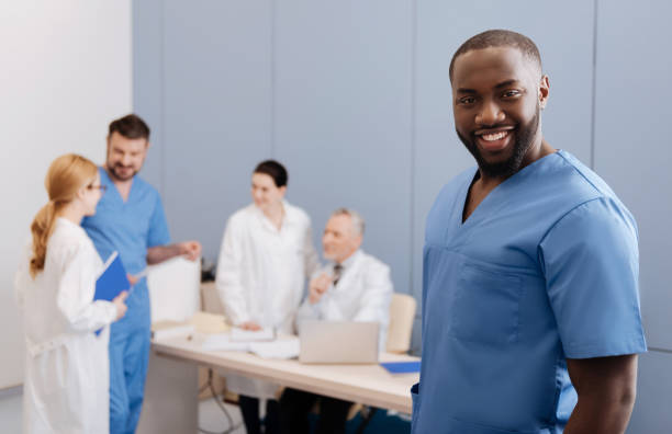 istock Positive young medic taking part in medical conference at work 669948518
