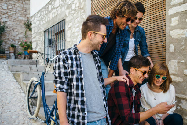 istock Group of laughing people with smartphone 669955056