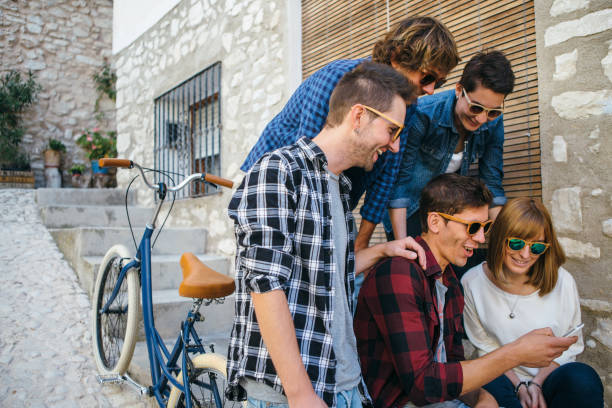 istock Trendy laughing friends with smartphone 669955110