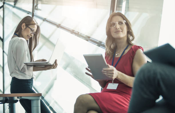 istock Business People in the Board Room Discussing, Using Laptop 669956074