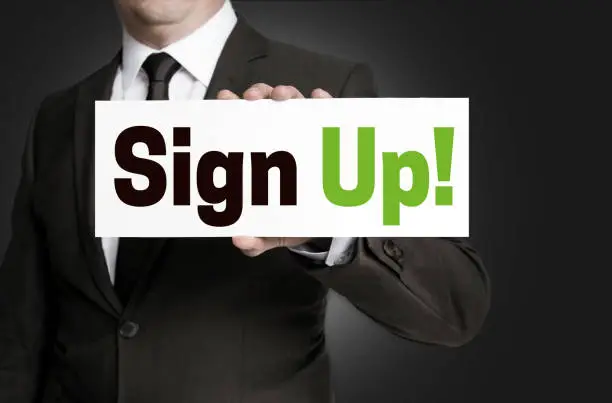 sign up plate held by businessman concept.