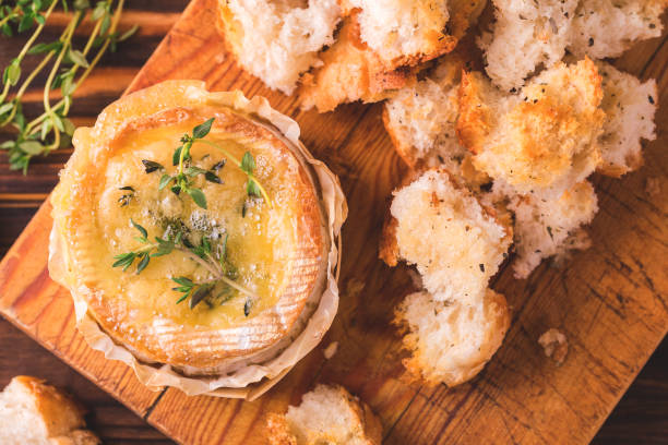 istock French baked Camembert cheese with thyme and baguette bread 669958900