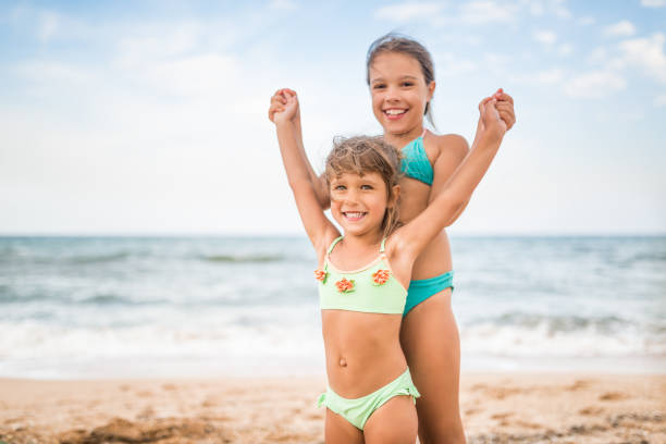 Kids having fun in water outdoors. 